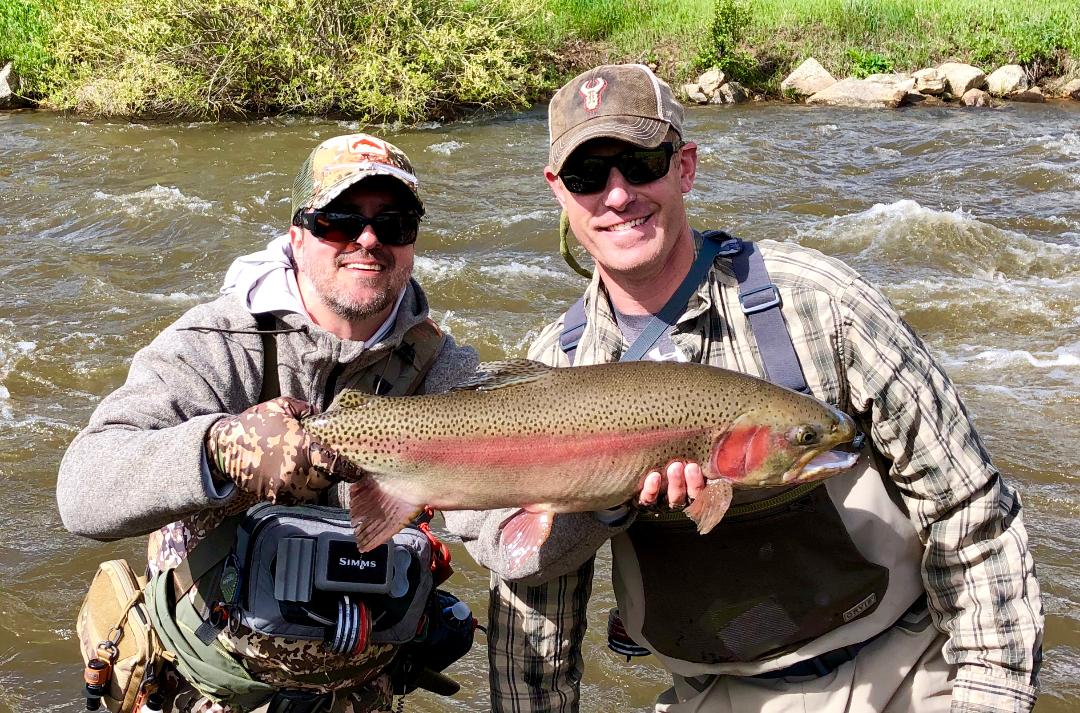Guide Angelo Arias with a very happy client from a guided fly fishing trip to private water near Denver.