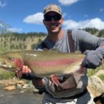 MLB pitcher Adam Wainwright with a trophy rainbow trout.