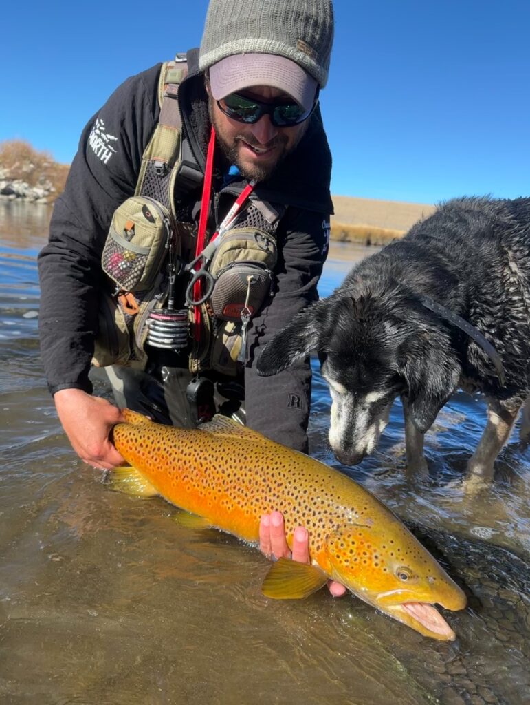 Danny Frank and his dog Rio with a big South Platte Brown Trout