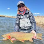Peggy with a giant lake run fish landed with guide Danny Frank