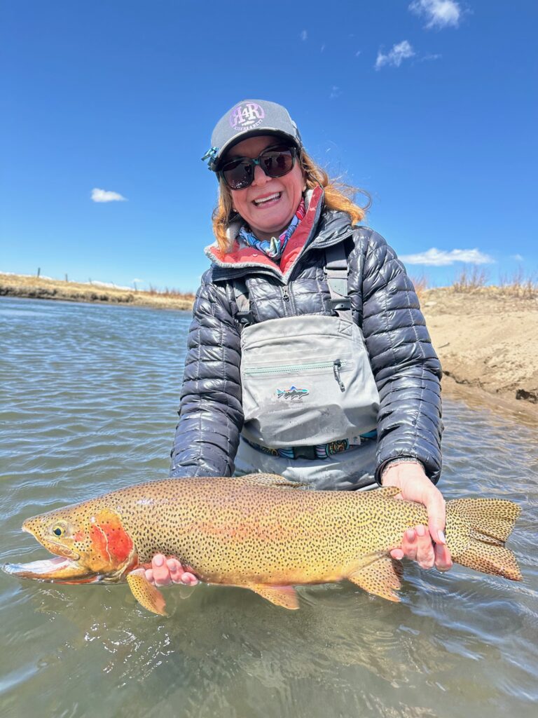 Peggy with a giant lake run fish landed with guide Danny Frank