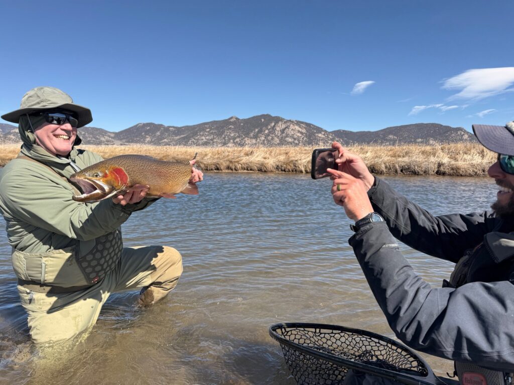 Danny Frank takes a photo of a happy client